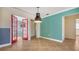 Bright dining room with tile floors and red doors leading to another room at 6725 Roxbury Dr, Sarasota, FL 34231