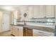 Kitchen with granite countertops and white cabinets at 6725 Roxbury Dr, Sarasota, FL 34231