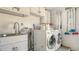 Laundry room with washer, dryer, and utility sink at 6725 Roxbury Dr, Sarasota, FL 34231