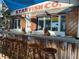 Starfish Company outdoor bar with wooden stools at 11907 45Th W Ave, Cortez, FL 34215