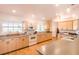 Modern kitchen with light wood cabinets, gray countertops, and stainless steel appliances at 1496 Palm View Rd, Sarasota, FL 34240