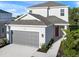Two-story house with gray garage door and red front door at 15033 Shady Palms Ln, Nokomis, FL 34275