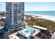 Aerial view of the condo with pool, sun deck, beach, and ocean in the background at 5400 Ocean Blvd # 10-2, Sarasota, FL 34242