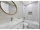 Modern bathroom with white quartz vanity, marble shower, and a white toilet at 14065 Paris Ln, Port Charlotte, FL 33981