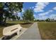 Community park with a walking path and bench at 14065 Paris Ln, Port Charlotte, FL 33981