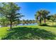 Picturesque backyard with a tranquil pond and lush green lawn, perfect for outdoor enjoyment and relaxation at 16920 Pelham Pl, Bradenton, FL 34202