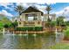 Community entrance featuring manicured landscaping, a serene pond, and a charming water fountain feature at 16920 Pelham Pl, Bradenton, FL 34202