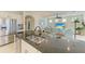 Kitchen island overlooking the living room features a stainless steel sink, dishwasher and granite counter at 16920 Pelham Pl, Bradenton, FL 34202