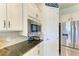 Close up of a counter area in a modern kitchen with stainless steel appliances and granite countertops at 16920 Pelham Pl, Bradenton, FL 34202