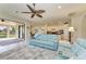 Open living room flows into dining area and kitchen, featuring sliding glass doors and comfortable seating at 16920 Pelham Pl, Bradenton, FL 34202