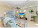 Bright living room featuring neutral walls, recessed lighting, a ceiling fan and a blue sofa set on a rug at 16920 Pelham Pl, Bradenton, FL 34202