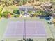 Aerial view showing home, tennis court, and lush landscaping at 2910 49Th St, Sarasota, FL 34234