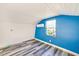 Cozy bedroom with blue accent wall and wood flooring at 2910 49Th St, Sarasota, FL 34234