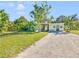 Ranch style home with grassy yard and driveway at 2910 49Th St, Sarasota, FL 34234