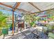 Outdoor fireplace and seating area under a pergola at 2910 49Th St, Sarasota, FL 34234