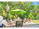 Private patio with seating area and green umbrella at 2910 49Th St, Sarasota, FL 34234