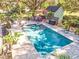 Inviting rectangular pool with surrounding patio and tropical landscaping at 2910 49Th St, Sarasota, FL 34234