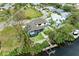 Aerial view of a waterfront home with private dock and lush landscaping at 901 30Th E Ct, Bradenton, FL 34208