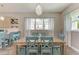 Light and airy dining room features a wood table and teal chairs at 901 30Th E Ct, Bradenton, FL 34208