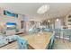 Open concept dining room with wood table and teal chairs at 901 30Th E Ct, Bradenton, FL 34208