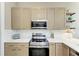 Stainless steel appliances and light wood cabinets in this kitchen at 901 30Th E Ct, Bradenton, FL 34208