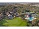 Aerial view of community clubhouse, pool, tennis courts, and golf course at 9908 Carnoustie Pl, Bradenton, FL 34211