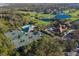 Aerial view of community with golf course, tennis courts, and pool at 9908 Carnoustie Pl, Bradenton, FL 34211