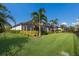 Landscaped backyard with lush lawn and screened pool area at 9908 Carnoustie Pl, Bradenton, FL 34211