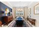 Formal dining room showcasing a dark wood table and blue accents at 9908 Carnoustie Pl, Bradenton, FL 34211