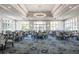 Bright dining room featuring ample seating and large windows at 9908 Carnoustie Pl, Bradenton, FL 34211