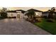 Attractive home with paver driveway and lush landscaping at 9908 Carnoustie Pl, Bradenton, FL 34211