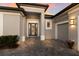 Inviting entryway with a modern door and a welcoming walkway at 9908 Carnoustie Pl, Bradenton, FL 34211