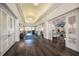 Elegant hallway with dark wood floors and white shutters at 9908 Carnoustie Pl, Bradenton, FL 34211