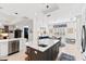 Modern kitchen with a spacious island, stainless steel appliances, and white cabinetry at 9908 Carnoustie Pl, Bradenton, FL 34211