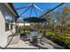 Screened patio with table and chairs, perfect for outdoor dining at 9908 Carnoustie Pl, Bradenton, FL 34211