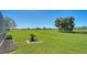 Landscaped backyard offering a serene golf course view at 10643 Old Grove Cir, Bradenton, FL 34212