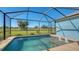 Inviting screened pool with spa and golf course view at 10643 Old Grove Cir, Bradenton, FL 34212