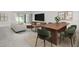 Open concept dining area with wood table and green chairs, adjacent to living room at 154 Mercer St, Port Charlotte, FL 33954