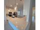 Modern kitchen island with white cabinets and quartz countertops at 16105 Old Fox Trl, Port Charlotte, FL 33953