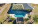 A high angle shot captures a private pool with a tiki hut, a covered pergola, and brick patio at 25205 67Th E Ave, Myakka City, FL 34251