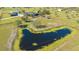 Expansive aerial view of a property featuring a large pond, house, and surrounding land at 25205 67Th E Ave, Myakka City, FL 34251