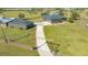 An aerial view shows the home, barn, and gated entry of this fenced property at 25205 67Th E Ave, Myakka City, FL 34251