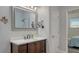 Modern bathroom with a dark wood vanity, white countertop, and a large mirror reflecting the walk-in shower at 25205 67Th E Ave, Myakka City, FL 34251