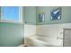 Bright bathroom featuring a white tub with white subway tile surround and light blue walls, creating a serene atmosphere at 25205 67Th E Ave, Myakka City, FL 34251