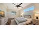 Bright bedroom with a large window, ceiling fan, and neutral decor, leading into the ensuite bathroom at 25205 67Th E Ave, Myakka City, FL 34251