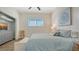 Comfortable bedroom with a large bed, soft blue bedding, ample natural light, and an open closet space at 25205 67Th E Ave, Myakka City, FL 34251