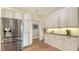 Kitchen featuring stainless refrigerator and abundant cabinetry with under-cabinet lighting at 25205 67Th E Ave, Myakka City, FL 34251