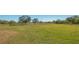 Open pasture with mature tree and perimeter fence at 25205 67Th E Ave, Myakka City, FL 34251