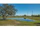 Scenic pond surrounded by lush greenery, offering a peaceful and natural setting at 25205 67Th E Ave, Myakka City, FL 34251