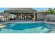 An outdoor pool with an overhang and an opening to the house at 25205 67Th E Ave, Myakka City, FL 34251